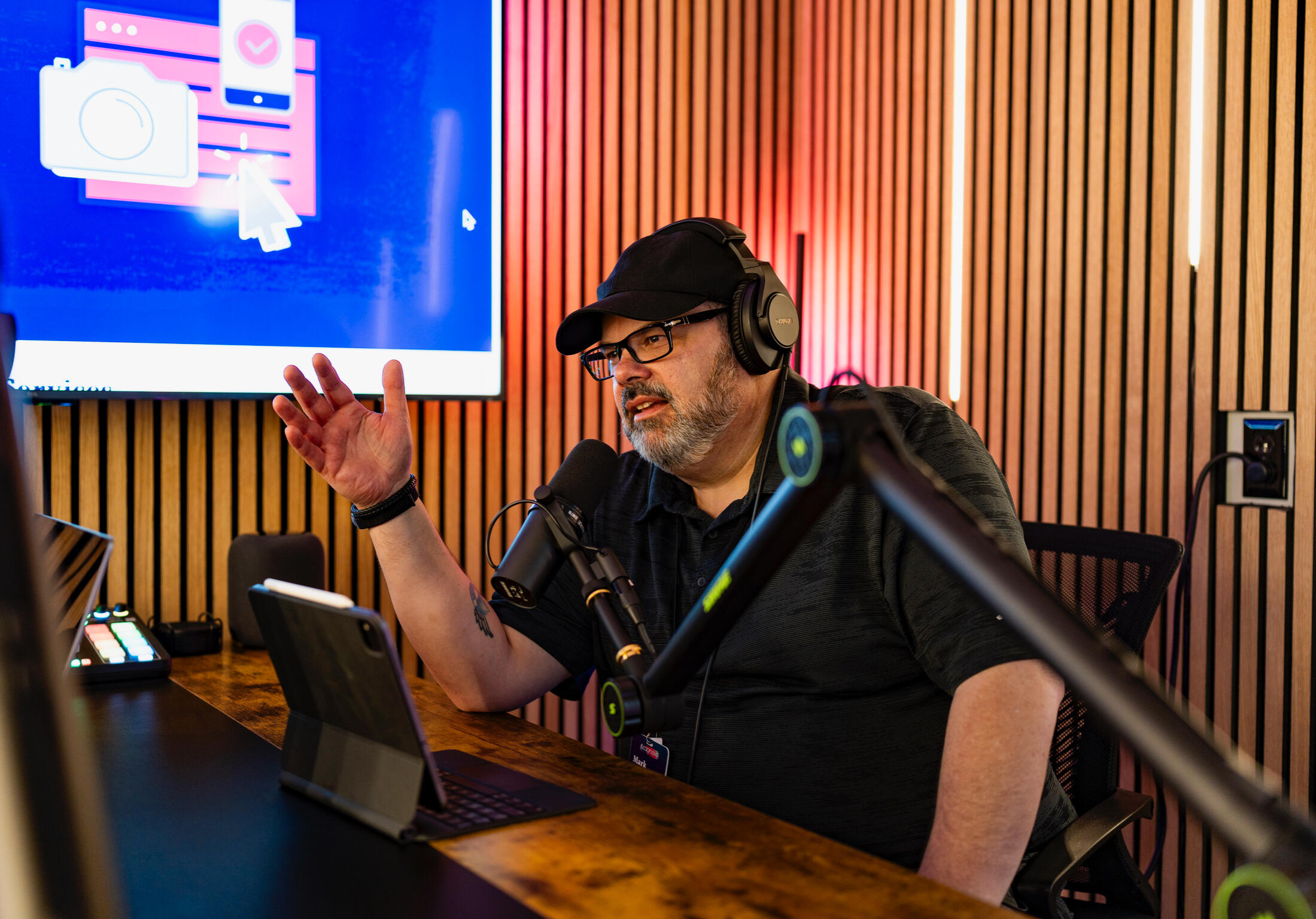 Mark Shropshire recording a podcast, wearing headphones and talking into a microphone